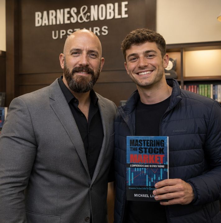 Michael Ligon at a book signing with a male reader for Mastering The Stock Market