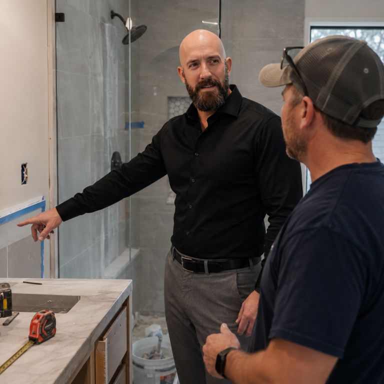 Michael Ligon reviewing renovation work with contractors on a Melbourne area property project